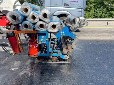 Asphalt reinforcement being installed